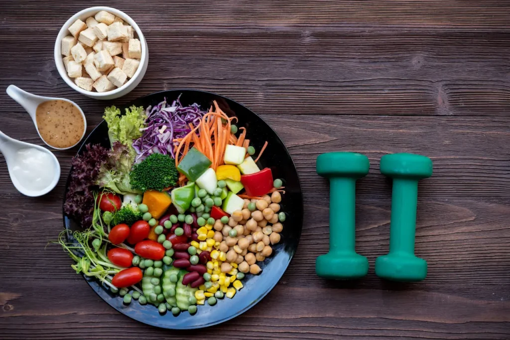 Fresh Healthy Meal With Weights On A Table